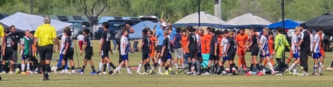 Youth soccer players gathering on a grass field
